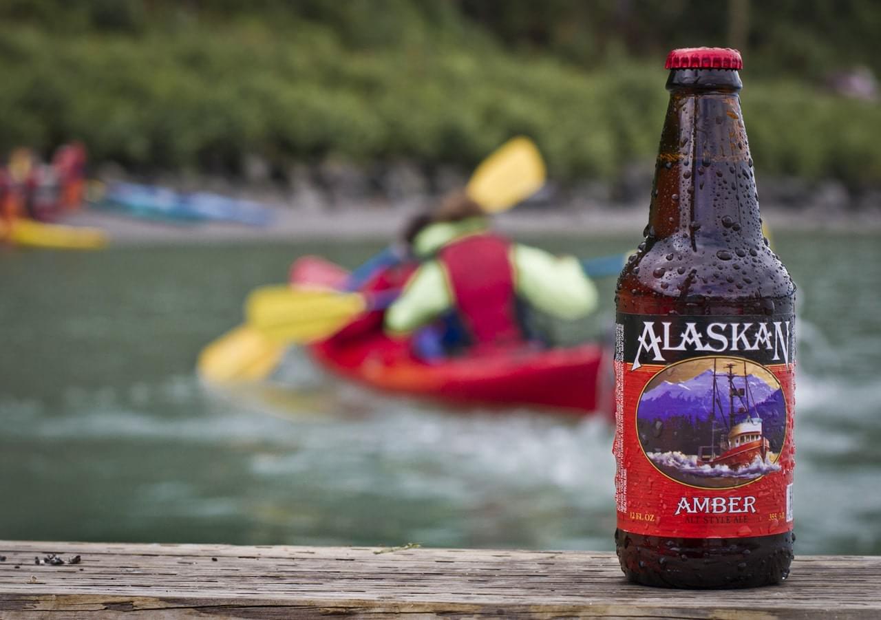Refreshing Alaska Amber beer bottle with condensation, perfect for outdoor adventures.