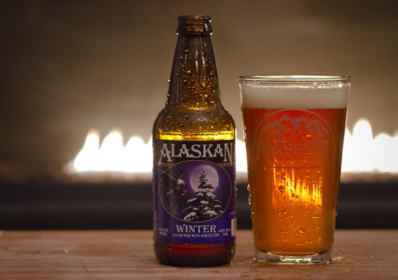 Alaskan Winter beer bottle and glass, cold with condensation, showcasing craft brewing excellence.